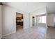 Bright dining room with tile flooring, view to the kitchen, and mirrored wall at 10858 E Sahuaro Dr, Scottsdale, AZ 85259