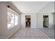 Open-concept dining area with tile flooring and view of the kitchen and backyard at 10858 E Sahuaro Dr, Scottsdale, AZ 85259