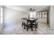 Bright dining room with ceiling fan, tiled floor, and adjacent white display cabinet at 10858 E Sahuaro Dr, Scottsdale, AZ 85259