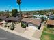Aerial view of a single-story home with desert landscaping and a basketball hoop on the driveway at 10858 E Sahuaro Dr, Scottsdale, AZ 85259
