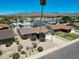 Aerial view of a single-story home with desert landscaping and a basketball hoop on the driveway at 10858 E Sahuaro Dr, Scottsdale, AZ 85259