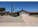 Inviting single-level home with a well-maintained front yard and a convenient two-car garage at 10858 E Sahuaro Dr, Scottsdale, AZ 85259
