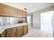 Kitchen flows into dining room with wooden cabinetry and white countertops at 10858 E Sahuaro Dr, Scottsdale, AZ 85259