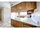 A view of kitchen featuring wooden cabinetry and white countertops at 10858 E Sahuaro Dr, Scottsdale, AZ 85259
