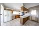 Traditional kitchen boasts wood cabinets, white appliances and tiled floor at 10858 E Sahuaro Dr, Scottsdale, AZ 85259