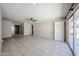 Bright living room featuring tile floors, neutral walls, and a built-in bookcase at 10858 E Sahuaro Dr, Scottsdale, AZ 85259