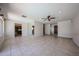 Expansive living room with tile flooring, a ceiling fan, and ample natural light at 10858 E Sahuaro Dr, Scottsdale, AZ 85259