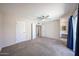 Spacious main bedroom with carpet flooring, ceiling fan, and ensuite bathroom entrance at 10858 E Sahuaro Dr, Scottsdale, AZ 85259
