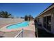 Backyard pool features desert landscaping, a low fence, and easy access to the home through sliding glass doors at 10858 E Sahuaro Dr, Scottsdale, AZ 85259
