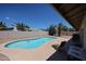 Private backyard pool with desert landscaping and patio furniture at 10858 E Sahuaro Dr, Scottsdale, AZ 85259