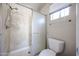 Shower area featuring frosted glass sliding doors, and an adjustable shower head at 10858 E Sahuaro Dr, Scottsdale, AZ 85259