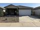 Charming single-story home featuring a two-car garage and low maintenance landscaping at 13179 E Verbina Ln, Florence, AZ 85132