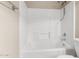 Clean bathroom featuring a white shower-tub combo, updated fixtures and toilet at 1334 E Helena Dr, Phoenix, AZ 85022