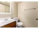 Bathroom with single sink vanity and toilet features neutral paint and a towel rack on the wall at 1334 E Helena Dr, Phoenix, AZ 85022