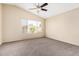 Bedroom with neutral paint and carpet has a vaulted ceiling, ceiling fan, and window with blinds at 1334 E Helena Dr, Phoenix, AZ 85022