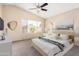 Staged bedroom with bed, side tables, lamps, wall art and a window with blinds at 1334 E Helena Dr, Phoenix, AZ 85022