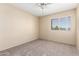 Neutral bedroom with carpet flooring, ceiling fan, and bright window at 1334 E Helena Dr, Phoenix, AZ 85022