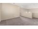 Bonus room with neutral paint and carpet has two arched cutout windows at 1334 E Helena Dr, Phoenix, AZ 85022