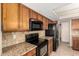 Traditional kitchen featuring granite countertops, tile backsplash, and stainless steel appliances at 1334 E Helena Dr, Phoenix, AZ 85022