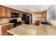 Traditional kitchen featuring granite countertops, tile backsplash, and stainless steel appliances at 1334 E Helena Dr, Phoenix, AZ 85022