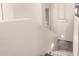 Carpeted staircase features a small wall cutout window and step lighting at 1334 E Helena Dr, Phoenix, AZ 85022