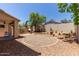 Well maintained backyard with gravel, desert plants, decorative landscaping, and block wall at 13420 W Berridge Ln, Litchfield Park, AZ 85340