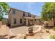 Expansive backyard featuring a covered patio, desert landscaping, and a charming walkway at 13420 W Berridge Ln, Litchfield Park, AZ 85340