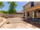 Flagstone and desert landscaping create a serene backyard oasis with a covered patio at 13420 W Berridge Ln, Litchfield Park, AZ 85340