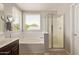 Bright bathroom with soaking tub, stand up shower, and white subway tile backsplash at 13420 W Berridge Ln, Litchfield Park, AZ 85340