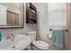 Cozy bathroom with a round sink, toilet, vanity, and a framed mirror at 13420 W Berridge Ln, Litchfield Park, AZ 85340
