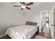 Guest bedroom with ceiling fan, wood floors, and plush bedspread at 13420 W Berridge Ln, Litchfield Park, AZ 85340