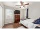 Small bedroom with hardwood floors, and closet, and a dark wood dresser at 13420 W Berridge Ln, Litchfield Park, AZ 85340