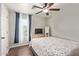 Comfortable bedroom with ceiling fan, wood floors, large window, and plush bedspread at 13420 W Berridge Ln, Litchfield Park, AZ 85340