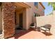 Cozy brick-paved front patio with seating, leading to the home's entrance at 13420 W Berridge Ln, Litchfield Park, AZ 85340