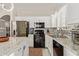 Well-lit kitchen featuring stainless steel appliances, granite countertops, and tile backsplash at 13420 W Berridge Ln, Litchfield Park, AZ 85340