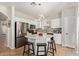 Modern kitchen featuring a center island with seating, white cabinets, and stainless steel appliances at 13420 W Berridge Ln, Litchfield Park, AZ 85340