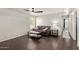 Comfortable living room featuring dark wood floors, contemporary decor, and plenty of natural light at 13420 W Berridge Ln, Litchfield Park, AZ 85340