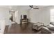 Spacious upstairs living room with dark wood floors and a ceiling fan at 13420 W Berridge Ln, Litchfield Park, AZ 85340