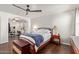 Bright main bedroom showcasing wood floors, furniture, and ample natural light at 13420 W Berridge Ln, Litchfield Park, AZ 85340