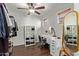 Organized walk-in closet with a vanity and storage, illuminated by natural light at 13420 W Berridge Ln, Litchfield Park, AZ 85340