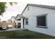 Private backyard with manicured turf, patio furniture, and charming string lights at 14344 W Hackamore Dr, Surprise, AZ 85387
