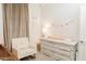 Bedroom featuring a rocking chair and a white changing table with drawers at 14344 W Hackamore Dr, Surprise, AZ 85387