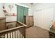 Neutral Bedroom featuring a gray crib, dresser, and sliding door closet for ample storage space at 14344 W Hackamore Dr, Surprise, AZ 85387