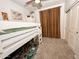 Bedroom featuring white bunk beds, a world map, and a sliding door closet at 14344 W Hackamore Dr, Surprise, AZ 85387