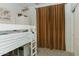 Bedroom featuring white bunk beds, a world map, and a sliding door closet at 14344 W Hackamore Dr, Surprise, AZ 85387