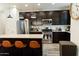 Open kitchen with stainless steel appliances, granite countertops, and a center island at 14344 W Hackamore Dr, Surprise, AZ 85387