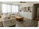 Comfortable living room with sofas, wood coffee table, built-in bookcase, and tile floors at 14344 W Hackamore Dr, Surprise, AZ 85387