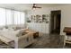 Comfortable living room with sofas, wood coffee table, built-in bookcase, and tile floors at 14344 W Hackamore Dr, Surprise, AZ 85387