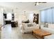 Bright, open-concept living area with kitchen, sofas, dining and tile flooring at 14344 W Hackamore Dr, Surprise, AZ 85387