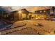 Expansive backyard featuring a pool, covered patio, and desert landscaping under a colorful sky at 14426 W Becker Ln, Surprise, AZ 85379